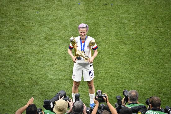 Megan Rapinoe of the United States poses with Golden Boot trohpy, Golden Ball trophy and World Cup championships trophy after the awarding ceremony of the 2019 FIFA Women's World Cup Final at Stade de Lyon in Lyon, France, July 7, 2019. (Xinhua/Chen Yichen)
