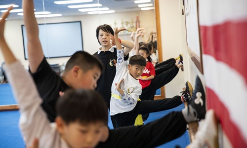 Lin Xu (rear), wife of Chen Sitan, teaches kids martial arts at Sitan Tai Chi and Martial Arts, a martial art school in Syosset of New York, the United States, Nov. 20, 2019. (Xinhua/Wang Ying)