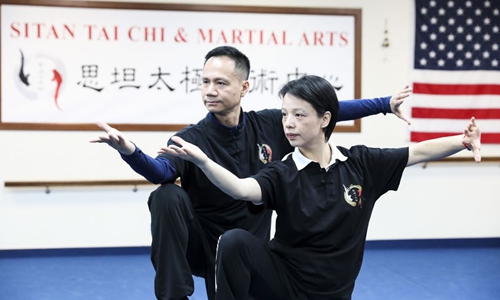 Chen Sitan (L) and his wife Lin Xu perform Tai Chi at Sitan Tai Chi and Martial Arts, a martial art school in Syosset of New York, the United States, Nov. 20, 2019. (Xinhua/Wang Ying)