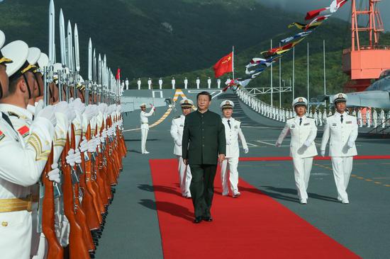 Chinese President Xi Jinping, also general secretary of the Communist Party of China Central Committee and chairman of the Central Military Commission (CMC), boards the aircraft carrier Shandong and reviews the guards of honor at a naval port in Sanya, south China's Hainan Province, Dec. 17, 2019. (Xinhua/Li Gang)