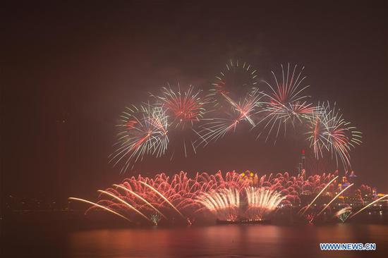 Fireworks explode over the sky of Macao and Zhuhai