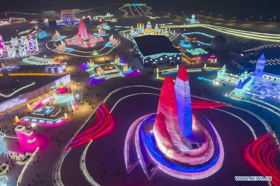 An aerial view of the 21st edition of Ice-Snow World is seen in Harbin, capital of northeast China's Heilongjiang Province, Dec. 23, 2019. (Photo by Xie Jianfei/Xinhua)