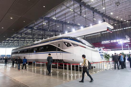 Visitors look at the CJ6 intercity EMU train manufactured by CRRC Zhuzhou Locomotive Co., Ltd. at the 2019 China International Rail Transit and Equipment Manufacturing Industry Expo in Changsha, central China's Hunan Province, Oct. 18, 2019. (Xinhua/Chen Sihan)