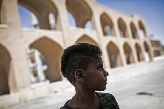 A local boy looks on as he stands at Amir Chakhmaq Complex in the historical city of Yazd in central Iran. UNESCO has added the historic city of Yazd to its list of world heritage sites on July 9, 2017. (Xinhua/Ahmad Halabisaz)