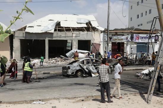 People are seen at the scene of a massive car bomb explosion in Mogadishu, capital of Somalia, on Jan. 8, 2020. (Xinhua/Hassan Bashi)