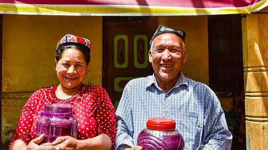 Xinhua's file photo of flower grower Ruz and his wife Tajinisa who show their handmade rose sauces at a village in Hotan, Northwest China's Xinjiang Uygur autonomous region.