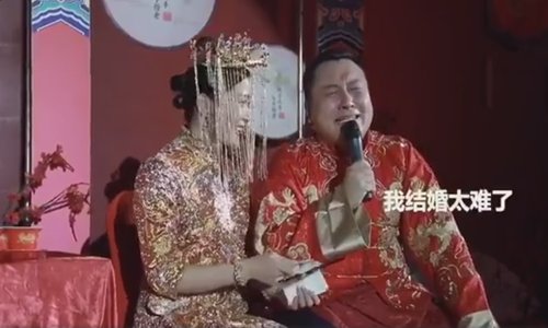A 30-year-old groom from Fuyang, East China's Anhui Province, bursts into tears at his wedding ceremony after being the best man at seven of his friends' weddings. His new wife helps wipe tears off his face as their guests laugh at the groom's heartfelt emotions. (Screenshot from Sina Weibo)