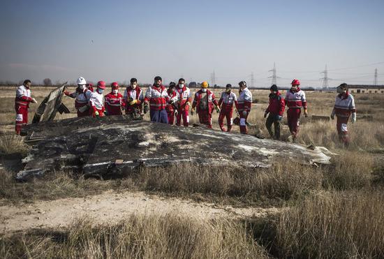 Rescuers work at the air crash site of a Boeing 737 Ukrainian passenger plane in Parand district, southern Tehran, Iran, on Jan. 8, 2020. (Xinhua/Ahmad Halabisaz)