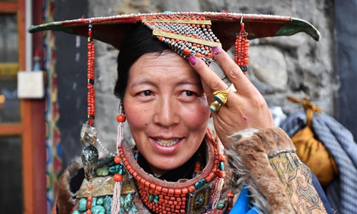 A woman wears Burang clothes in Burang county of Ali, Southwest China's Tibet Autonomous Region, July 22, 2019. Burang clothes has a history of more than 1,000 years. It is decorated with gold, silver, pearls and other jewels. (Photo/Xinhua)