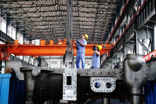 Employees work on the production line of a steam turbine manufacturer in Harbin, capital of Heilongjiang Province. (Photo/Xinhua)