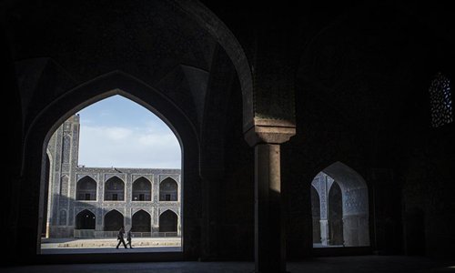 People walk at a mosque in Naghshe Jahan Square in Isfahan, Iran, on July 17, 2019. Constructed between 1598 and 1629, Isfahan is now an important historical site, and one of UNESCO's World Heritage Sites. (Photo/Xinhua/Ahmad Halabisaz)

