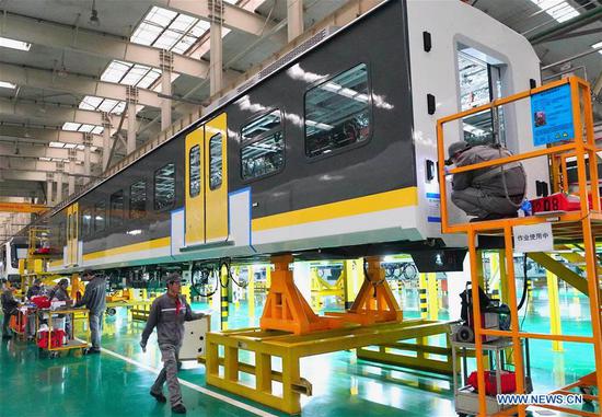 People work on a production line of CRRC Tangshan Co., Ltd. in Tangshan, north China's Hebei Province, Dec. 31, 2019. China's economy grew 6.1 percent year on year in 2019, within the government's annual target of 6 to 6.5 percent, the National Bureau of Statistics (NBS) said on Friday. (Xinhua/Yang Shiyao)