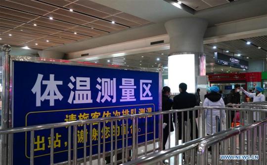 Staff members measure temperatures of passengers at Nanchang West Railway Station in Nanchang, east China's Jiangxi Province, Jan. 29, 2020. Various measures are taken across China to combat the novel coronavirus. (Xinhua/Hu Chenhuan)