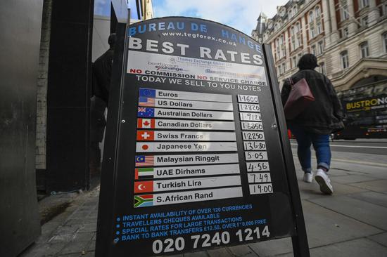 A pedestrian walks past a currency exchange in London, Britain, on Feb. 1, 2020.(Photo by Stephen Chung/Xinhua)