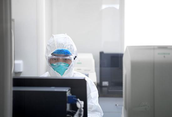 A researcher works at the disease prevention and control center in Nanyang, central China's Henan Province, Feb. 4, 2020. (Photo by Hao Yuan/Xinhua)