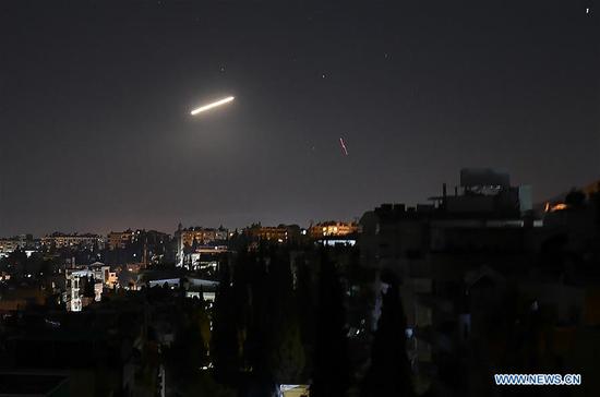 Syrian air defense missile is seen in the sky over Damascus, capital of Syria, Feb. 6, 2020. Syria's air defense was triggered early Thursday by a fresh Israeli missile attack over the capital Damascus, Syrian state TV reported. The missiles, launched from the Israeli-occupied Golan Heights, targeted areas west of Damascus, as people there heard powerful explosions, said the report. The air defense intercepted several missiles, and the exact targets are not clear, it said. (Photo by Ammar Safarjalani/Xinhua)