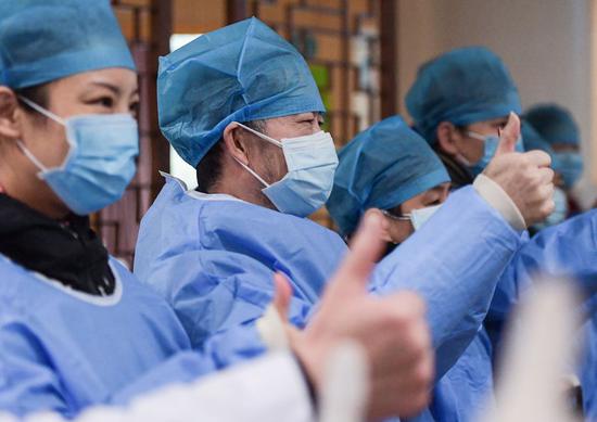 Cured novel coronavirus pneumonia patients cheer for themselves in a hospital in Wuhan, central China's Hubei Province, Feb. 6, 2020. (Xinhua/Li He)