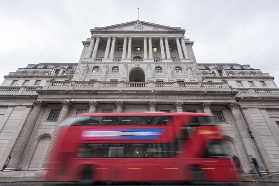 A double-decker red bus passes by the Bank of England in London, Britain on March 6, 2019. (Xinhua/Stephen Chung)
