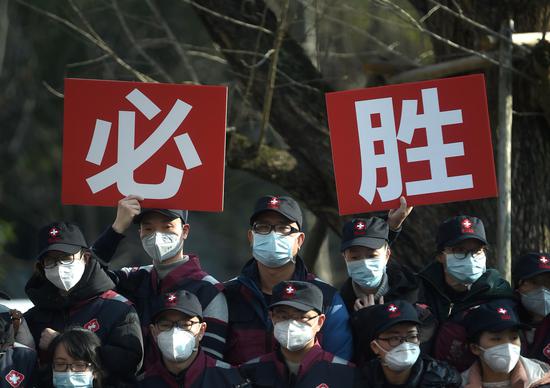 Medical team members hold banners meaning 