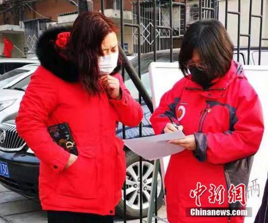 Community workers check in front of a community in Shijingshan District, Beijing, Feb. 1, 2020. (Photo/China News Service）