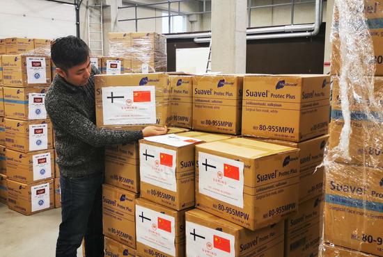 Overseas Chinese checks medical supplies donated to China at a warehouse in Helsinki, Finland, Jan. 31, 2020. (Xinhua/Zhu Haochen)