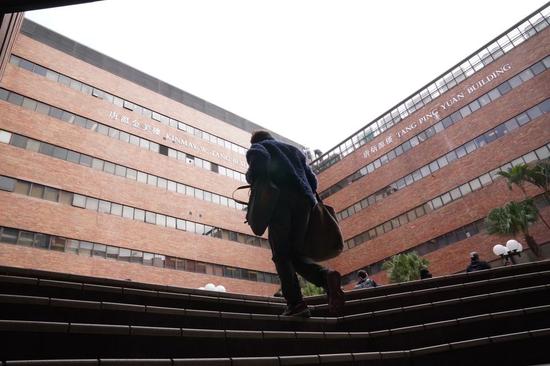 Students and staff walk into the campus of Hong Kong Polytechnic University (PolyU) in Hong Kong, south China, Jan. 13, 2020. (Xinhua)