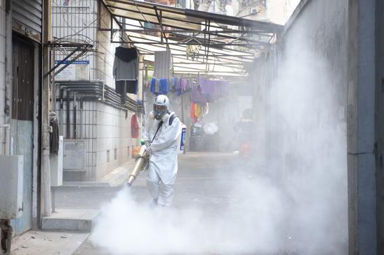 A Changsha Blue Sky Rescue volunteer sprays disinfectant in Mawangjie community in Changsha, central China's Hunan Province, Feb. 5, 2020. (Xinhua/Chen Zhenhai)