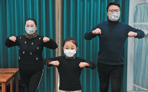 A family in Chongqing exercises at home. WANG QUANCHAO/XINHUA