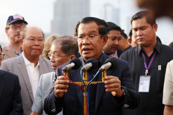 Cambodian Prime Minister Samdech Techo Hun Sen speaks as he greets passengers onboard the Westerdam cruise ship at southwest Cambodia's sea port of Sihanoukville on Feb. 14, 2020. (Photo by Li Lay/Xinhua)