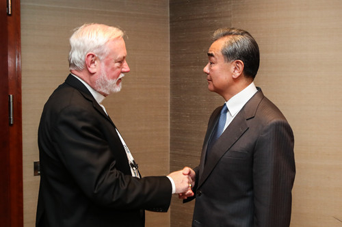Chinese State Councilor and Foreign Minister Wang Yi (R) shakes hands with Vatican's Secretary for Relations with States Paul Gallagher on the sidelines of the Munich Security Conference, in Munich, Germany, February 14, 2020. /Photo via Chinese Foreign Ministry website