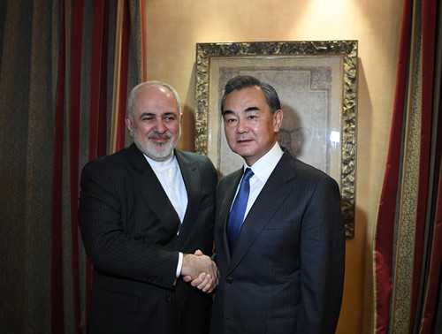 Chinese State Councilor and Foreign Minister Wang Yi (R) shakes hands with Iranian Foreign Minister Mohammad Javad Zarif on the sidelines of the Munich Security Conference, in Munich, Germany, February 14, 2020. /Photo via Chinese Foreign Ministry website