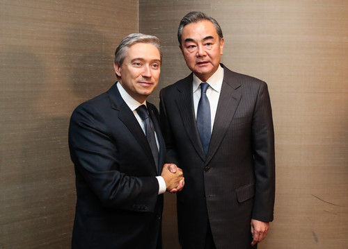 Chinese State Councilor and Foreign Minister Wang Yi (R) shakes hands with Canadian Foreign Minister Francois-Philippe Champagne on the sidelines of the Munich Security Conference, in Munich, Germany, February 14, 2020. /Photo via Chinese Foreign Ministry website