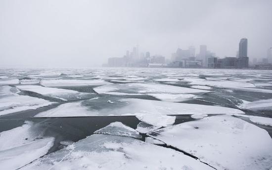 Toronto skyline is seen with floating ice on Lake Ontario in Toronto, Canada. (Xinhua/Zou Zheng)