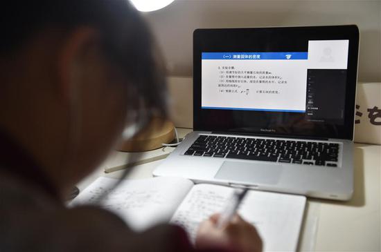 Student Huang Yahui takes online course at her home in Fengtai District of Beijing, capital of China, Feb. 17, 2020. The beginning of the spring semester of 2020 in Beijing is delayed due to the novel coronavirus epidemic. Middle and primary school students in Beijing, under the instruction of teachers, started to take online courses supplementarily on Monday, the original starting date of the spring semester. (Photo by Chen Zhonghao/Xinhua)