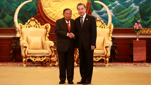 Bounnhang Vorachit (L), general secretary of the Lao People's Revolutionary Party Central Committee and president of Laos, meets with Chinese State Councilor and Foreign Minister Wang Yi in Vientiane, Laos, February 20, 2020. /Photo via Chinese Foreign Ministry