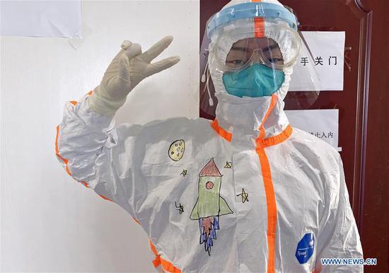 Undated photo shows a medical staff member showing the drawing on the protective suit at the isolation ward of children infected with novel coronavirus pneumonia in Wuhan Children's Hospital in Wuhan, central China's Hubei Province. (Wuhan Children's Hospital/Handout via Xinhua)