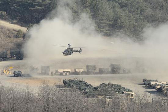 An armored helicopter prepare to land on the ground during the annual joint military exercise Foal Eagle between South Korea and the United States in Pocheon, northeast of Seoul, March 25, 2015. (Xinhua/Seongbin Kang)