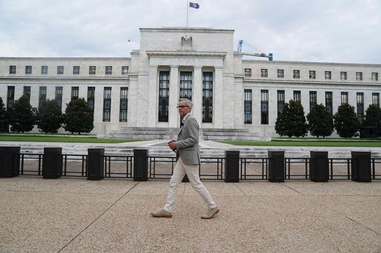 A man walks by the U.S. Federal Reserve building in Washington D.C., the United States, on July 31, 2019. (Xinhua/Liu Jie)
