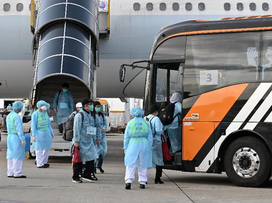Hong Kong residents board a coach to depart for the quarantine facility after arriving at Hong Kong airport from Wuhan, central Hubei Province, March 5, 2020. (Photo provided by HKSAR gov't)