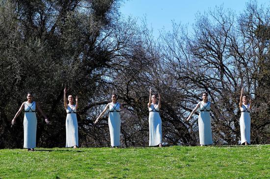 Performers are seen during the lighting ceremony in Ancient Olympia, Greece, on March 12, 2020. The Olympic Flame which will be burning for the Tokyo 2020 Olympics was ignited in Ancient Olympia in western Greece, the birthplace of the Games, on March 12, 2020. (Xinhua/Antonis Nikolopoulos)