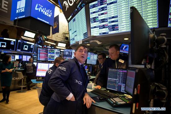 Traders work at the New York Stock Exchange in New York, the United States, March 16, 2020.  (Photo by Michael Nagle/Xinhua)