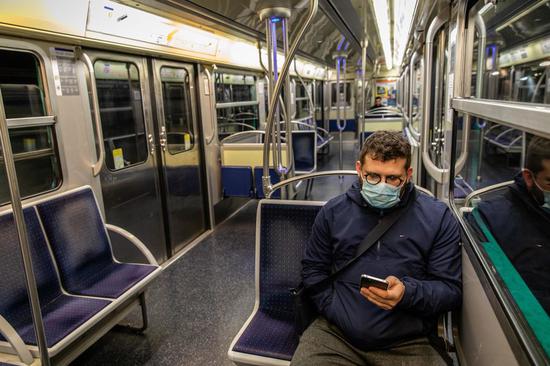 A man wearing a mask takes the metro in Paris, France, March 19, 2020. (Photo by Aurelien Morissard/Xinhua)