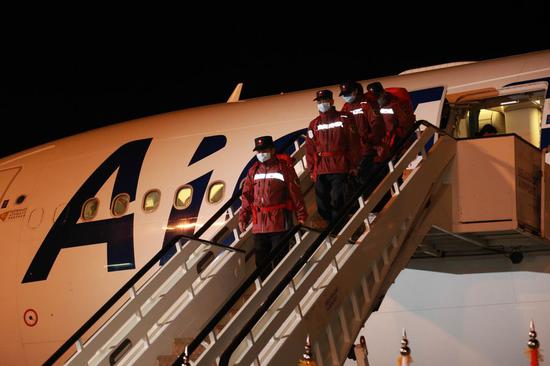 Chinese medical team members step off the plane upon arrival in Belgrade, Serbia, March 21, 2020. (Xinhua/Shi Zhongyu)