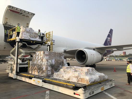 Workers unload emergency medical supplies provided by Chinese government at Hazrat Shahjalal International Airport in Dhaka, Bangladesh, March 26, 2020. (Xinhua/Liu Chuntao)