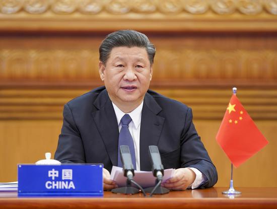 President Xi Jinping speaks during the G20 Extraordinary Leaders' Summit on COVID-19 on Thursday. The president participated in the summit, which was in the form of a videoconference, at the Great Hall of the People in Beijing. (Photo/Xinhua)