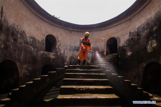 A man sprays disinfectant at Taman Sari site in Yogyakarta palace complex, Indonesia, March 31, 2020. Indonesian President Joko Widodo on Tuesday declared a public health emergency status in a bid to contain the COVID-19 pandemic in the country. (Photo by Damar/Xinhua)