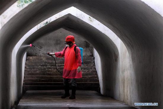 A man sprays disinfectant at Taman Sari site in Yogyakarta palace complex, Indonesia, March 31, 2020.  (Photo by Damar/Xinhua)