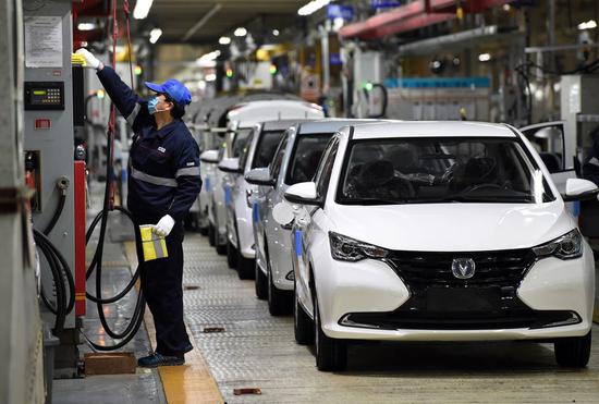 A man works at a workshop of Hefei plant of Changan Automobile in High-tech Industry Development Zone in Hefei, east China's Anhui Province, Feb. 26, 2020. (Photo by Zhou Mu/Xinhua)