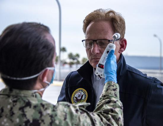 Acting Secretary of the Navy Thomas Modly has his temperature read as part of a COVID-19 screening prior to a tour of the Military Sealift Command hospital ship USNS Mercy (T-AH 19), March 31, 2020. (U.S. Navy photo by Mass Communication Specialist 2nd Class Natalie M. Byers/Released)