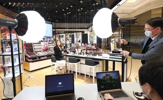 Staff prepare for a livestreaming sale at the New World Daimaru Department Store in east China's Shanghai, March 20, 2020. (Xinhua/Chen Fei)